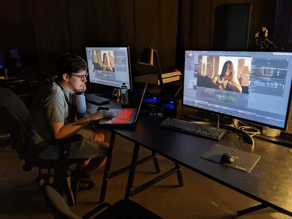 man editing video on computer