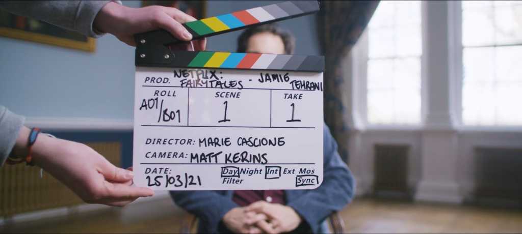 Clapperboard in front of an actors face for a netflix show
