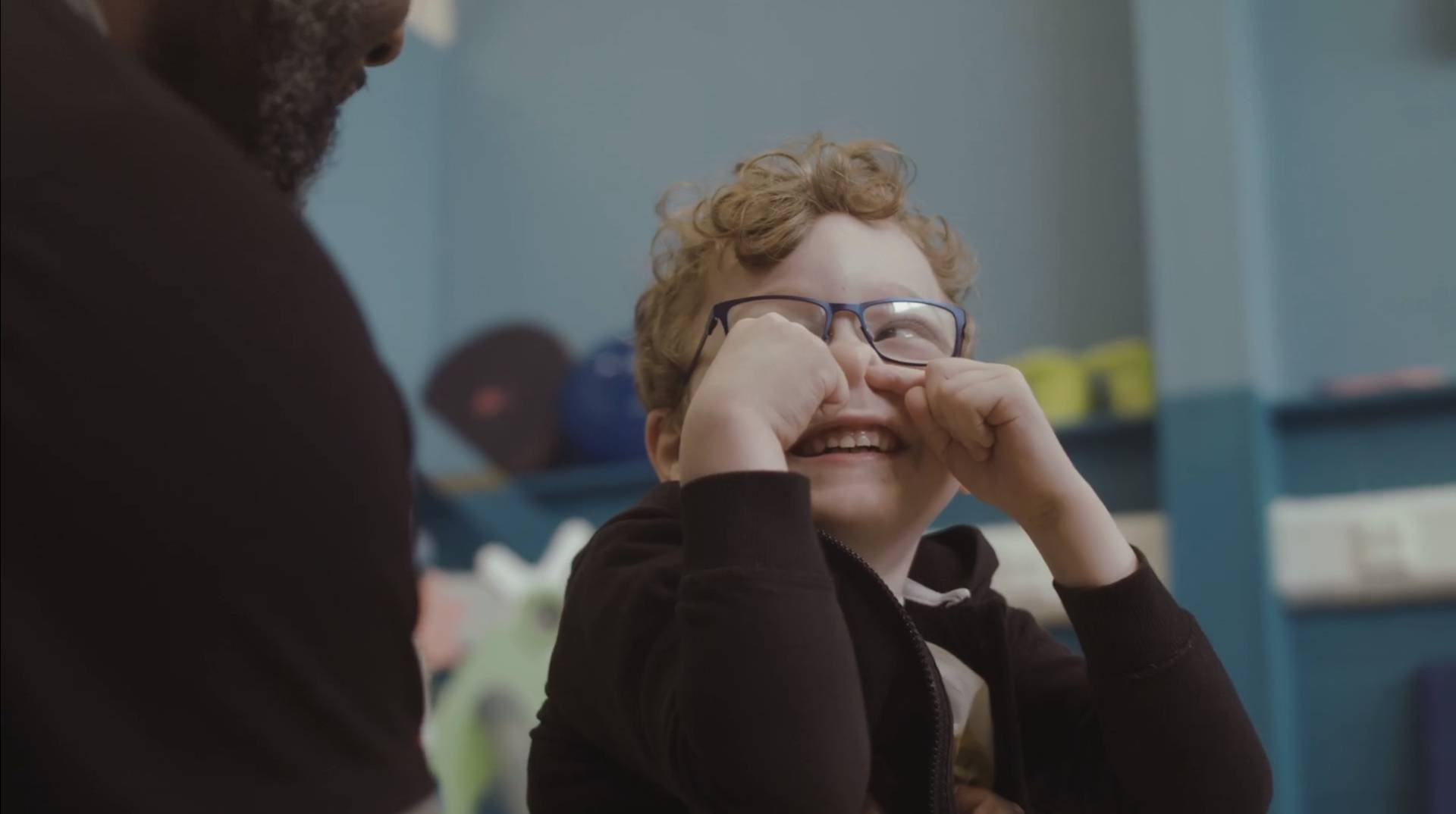 child smiling at an adult