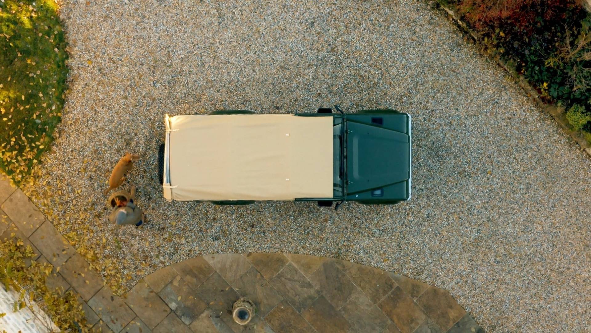 Birds eye view drone photo of a green car with a white roof