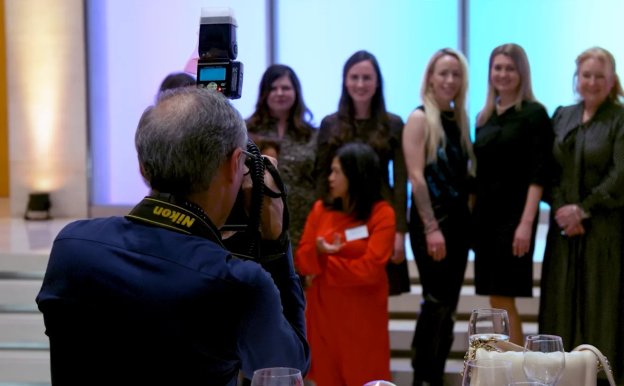 Group of people at an event standing to get their picture taken