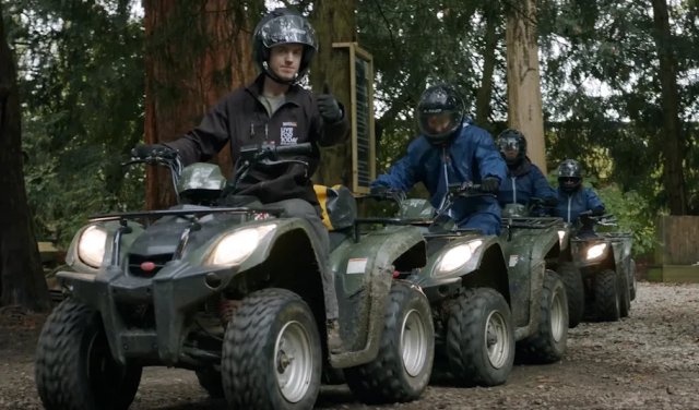 People driving quadbikes in a line