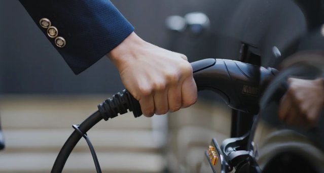 A hand filling up a car with petrol