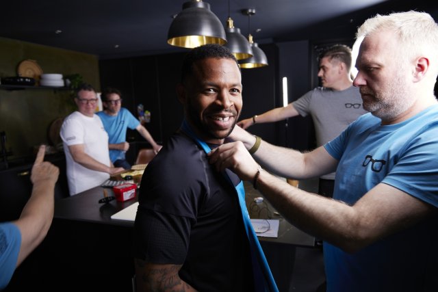 Behind-the-scenes shot of a videography team making sure the actors are camera-ready